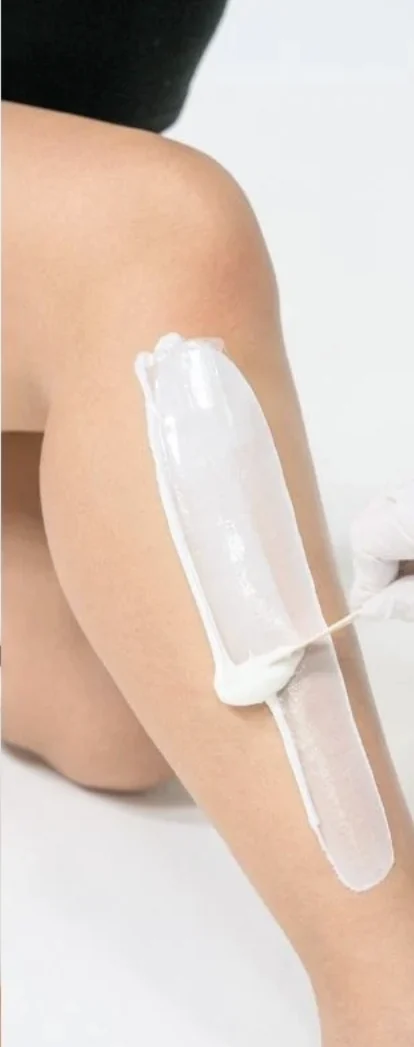 Wax being gently removed during a leg waxing treatment