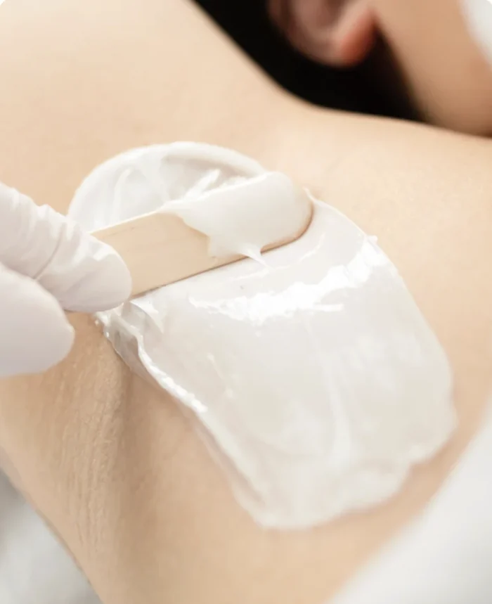 A close-up of an underarm waxing treatment